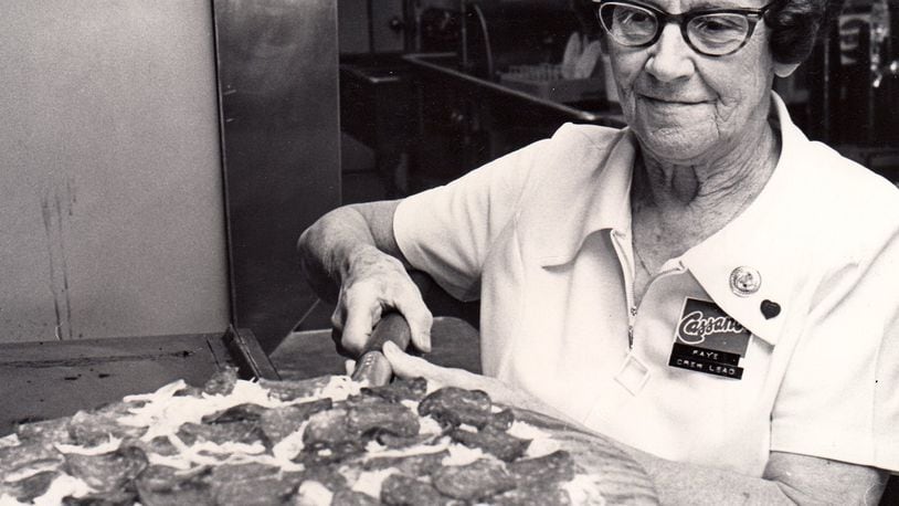 Faye Cameron displays a Cassano Pizza Kings pizza at the North Main Street location in 1976. DAYTON DAILY NEWS ARCHIVE