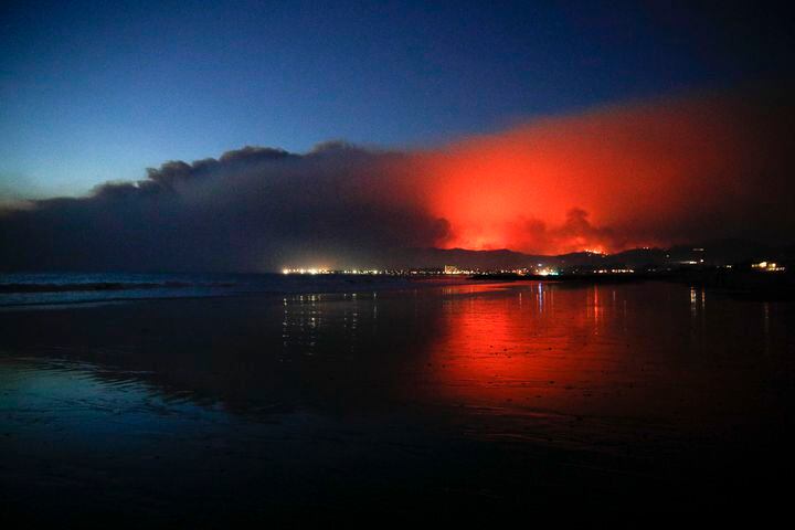 The Latest: California wildfire hops highway, nears ocean