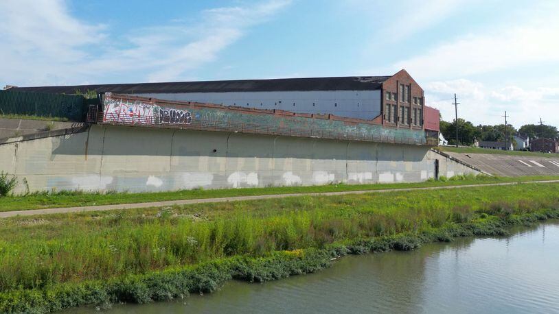 The Hamilton StreetSpark program is asking artists to submit qualifications for one of the largest murals the iniatitive plans to undertake. Pictured is the levee wall by the site that will be the Crawford Hoying development across from Spooky Nook. NICK GRAHAM/STAFF