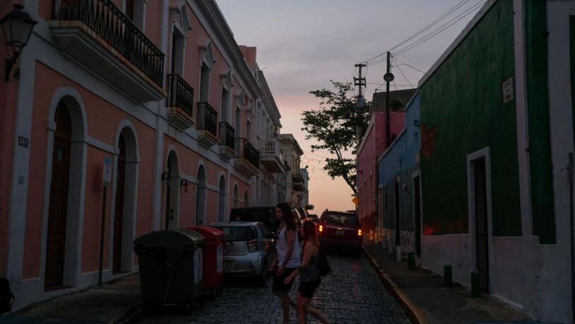 Tourists walk along San Sebastian street on April 18, 2018 in Old San Juan, Puerto Rico as a major failure knocked out the electricity in Puerto Rico today, leaving the entire island without power nearly seven months after Hurricane Maria destroyed the electrical grid.
