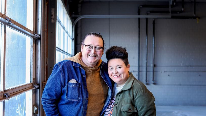 Brycen (L) and Claire Cross took a risk in 2022 and decided to open a locally based outdoor retail store. They posed in their unfinished space this month. Base Camp Outdoors Co. will open on First Street in Downtown Dayton this summer.