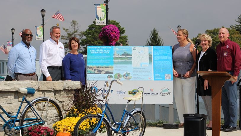 On Sept. 29, 2023 in Troy, Miami Valley leaders celebrated the first mile of local paved trail, constructed in 1973, of what has grown into the nation's largest connected paved trail network. From left are Brian Martin of MVRPC, Miami County Commissioner Wade Westfall, Melissa Kleptz of the Troy Foundation, MaryLynn Lodor of the Miami Conservancy District, Troy Mayor Robin Oda and Scott Myers of the Miami County Park District. Contributed Photo courtesy the Miami Conservancy District