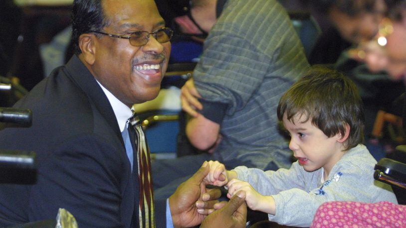 Ricky Boyd, who worked for the Montgomery County Combined Health District for a quarter-century, died Oct. 28, 2018. He is shown in an archive photo as he danced with a child at the 25th Annual Christmas Party for the Mentally Retarded/Mentally Handicapped. FILE