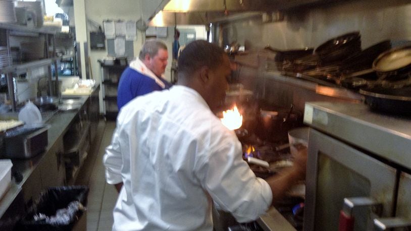 Wellington Grille Chef Durell Harrison staying busy in the Beavercreek eatery’s kitchen. The restaurant is one of several to close recently. (Staff photo by Amelia Robinson)