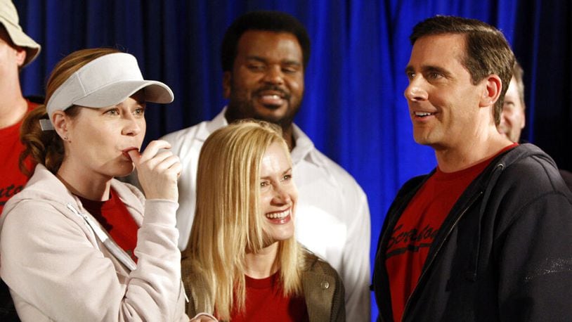 FILE - In this April 14, 2009, file photo cast members, from left, Jenna Fischer, Angela Kinsey, Craig Robinson, and Steve Carell are seen after cutting a cake celebrating the 100th episode of the television show "The Office."