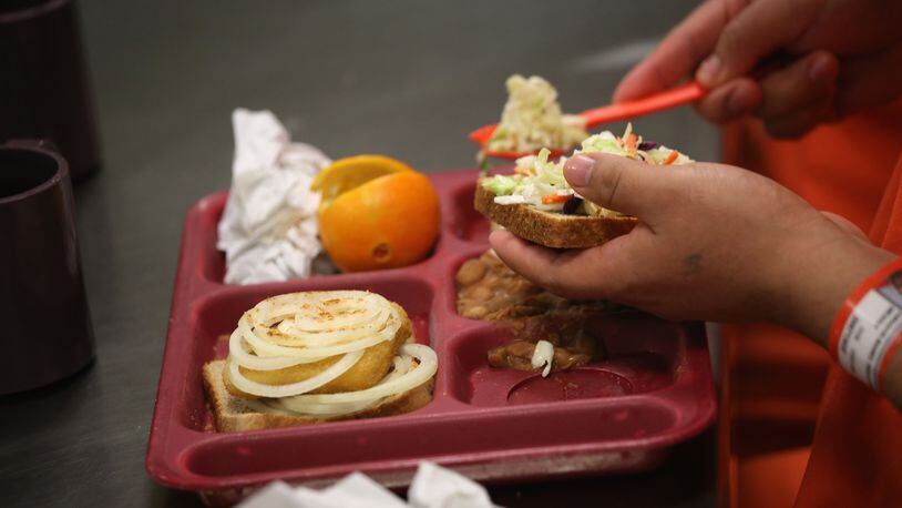Immigrant detainees eat lunch, one of three meals a day, at the Adelanto Detention Facility on November 15, 2013 in Adelanto, California. Immigrants and activists say privately owned immigration detention facilities deliberately skimp on essentials, even food, to coerce detainees to labor for pennies an hour to supplement meager rations, Reuters reported.