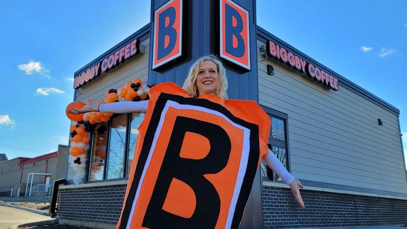 Butler County’s first Biggby Coffee shop is opening today in downtown Hamilton at 1055 High St. It will be the third location for franchisee’s Dustin and Amy Hepburn, who live in Loveland. Amy attended Monday's ribbon-cutting and wore her Biggby costume. NICK GRAHAM/STAFF