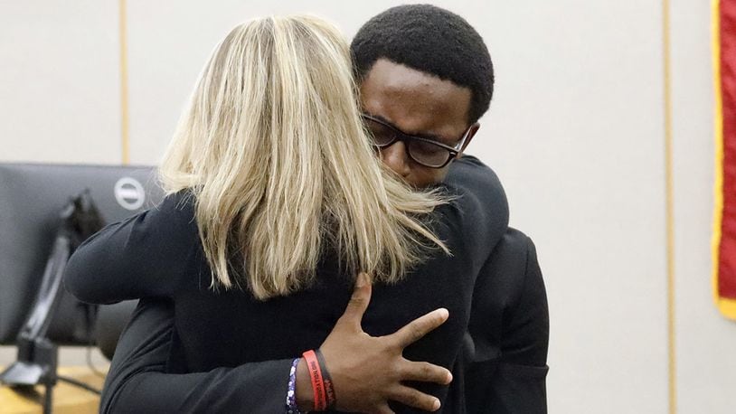 Botham Jean's younger brother Brandt Jean hugs convicted murderer and former Dallas Police Officer Amber Guyger after delivering his impact statement to her after she was sentenced to 10 years in jail,(Tom Fox/The Dallas Morning News via AP, Pool)