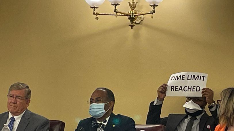 Ohio Redistricting Commission members (l-r) House Speaker Bob Cupp, R-Lima, and Sen. Vernon Sykes, D-Akron, listen to a member of the public at the commission's Sept. 14, 2021 hearing as a staff member holds up a time-limit sign.