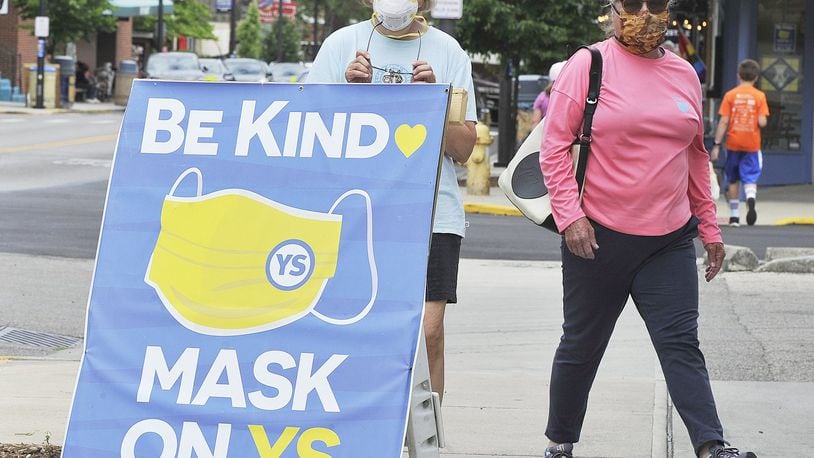 Jeannine Neubauer, left, and Meg Huey, walked around Yellow Springs wearing masks Thursday. The Village passed a resolution to make it a requirement to wear a mask and properly social distance while in the “business district” of Yellow Springs. MARSHALL GORBYSTAFF
