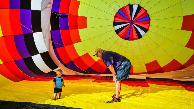 FILE PHOTO: Sean Askren stands with his grandson Asher Motley inside his hot air balloon "Bohica" as it is inflates during a media preview of a previous Ohio Challenge. The year's Ohio Challenge will be Friday and Saturday at Smith Park. NICK GRAHAM/STAFF