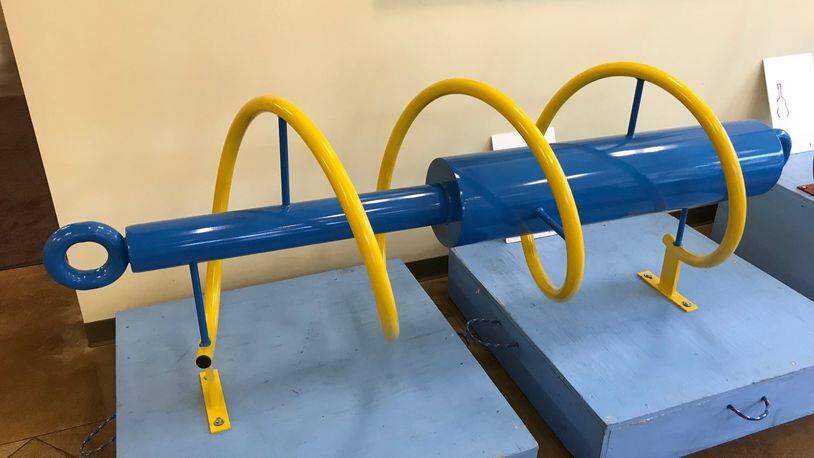 The shock absorber bike rack was donated by Thyssenkrupp Bilstein and will be mounted at the trailhead to the Great Miami River recreational trail. NICK GRAHAM/STAFF