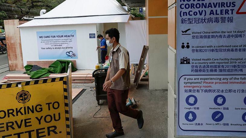 Workers set up a quarantine area for patients with recent travel history from China or those with symptoms of the new virus outside a private hospital in Manila, Philippines on Friday, Jan. 31, 2020.