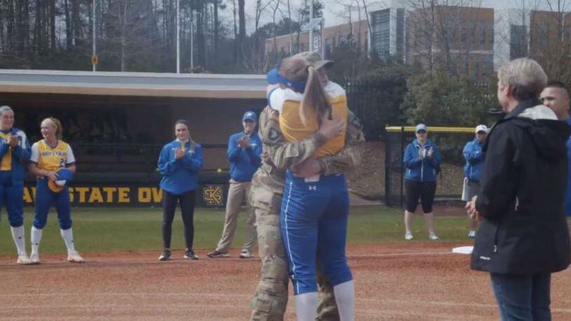 A soldier in Afghanistan surprised his sister at her softball game. (Photo: Kennesaw State University)
