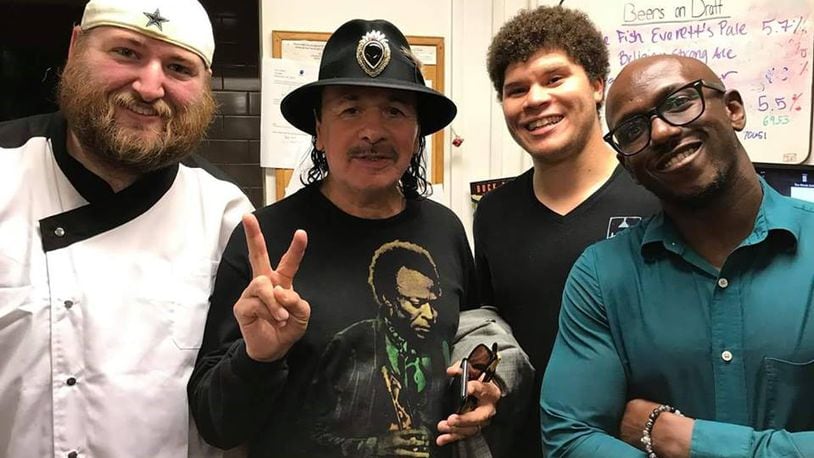 Carlos Santana was spotted at The Winds Cafe on Saturday night having dinner. He posed for a photo with the restaurant's kitchen staff. (Photo via The Winds Cafe Facebook page)