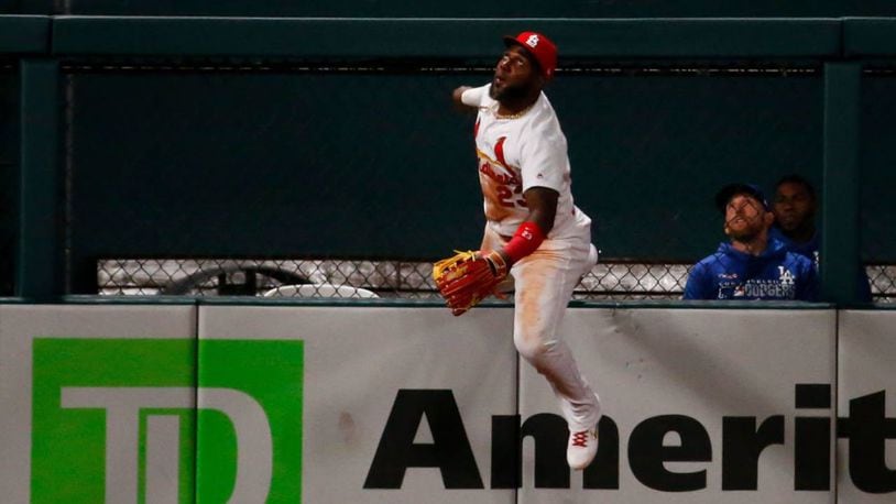 Cardinals outfielder Marcel Ozuna scaled the wall at Busch Stadium but misjudged how far the ball was hit.
