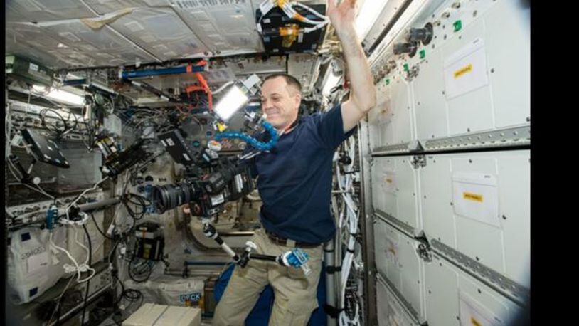 Astronaut Ricky Arnold uses the new 8K camera as he works aboard the International Space Station.