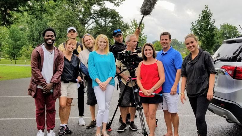 Indian Lake realtor Paige Duff (blue shirt) is pictured with Dayton area residents Chris and Tina Gibbs (second and third from right) and members the crew of HGTV's "Island Life."
