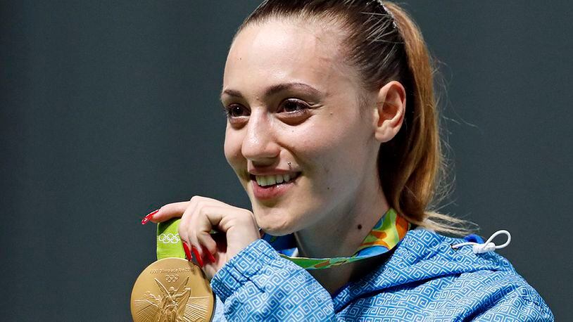 In this Aug. 9, 2016, file photo, Anna Korakaki, of Greece, displays her gold medal following the victory ceremony for the women's 25-meter pistol event at the 2016 Summer Olympics in Rio de Janeiro, Brazil. Greece's Olympic committee said Thursday, Feb. 6, 2020, it has picked Korakaki as the first torchbearer for the 2020 Tokyo Games following the flame-lighting ceremony in Ancient Olympia on March 12. It's the first time a woman has been chosen for the launch of the torch relay. (Hassan Ammar/AP)