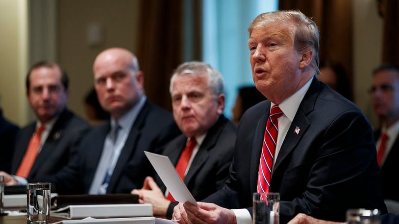 President Donald Trump speaks during a cabinet meeting at the White House, Tuesday, Feb. 12, 2019, in Washington. From left, Secretary of Health and Human Services Alex Azar, acting Attorney General Matthew Whitaker, Deputy Secretary of State John Sullivan, and Trump. (AP Photo/ Evan Vucci)