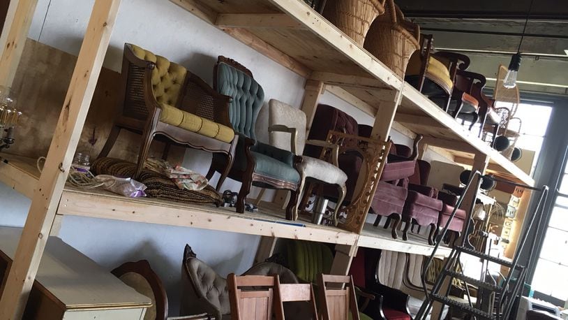 The inventory at Something Old Dayton is constantly expanding -- here industrial shelves hold most of the company's furniture for rent. (TABATHA WHARTON/STAFF)