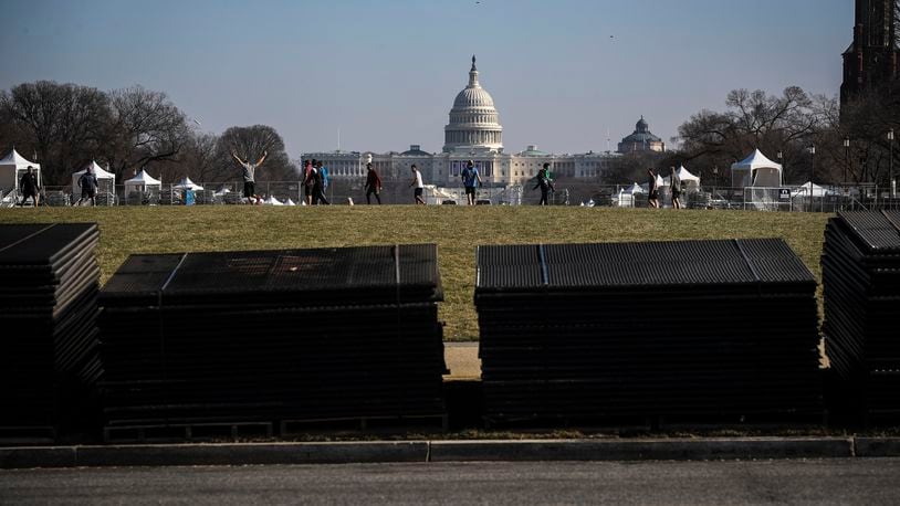 Temporary security fencing is stacked on the National Mall near the Capitol in Washington on Tuesday, Jan. 12, 2021, in advance of Inauguration Day. Security experts have warned that some far-right extremist groups have now started to focus attention on Inauguration Day and are already discussing an assault similar to the one on the Capitol last week. (Oliver Contreras/The New York Times)