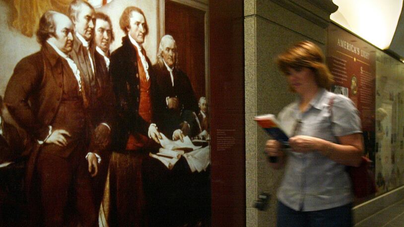 A visitor passes by a picture named "The Declaration of Independence" by John Trumbull showing members of the committee appointed by the Continental Congress to draft the Declaration, (L-R) John Adams, Roger Sherman, Robert Livingston, Thomas Jefferson and Benjamin Franklin, at Thomas Jefferson Memorial October 14, 2004 in Washington, DC.  (Photo by Alex Wong/Getty Images)