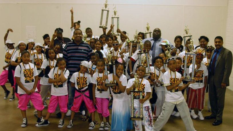 Dayton promoter Tommy Owens Jr. (man in striped shirt) is pictured with former winners and participants in the Family Affair Talent Show. The other adults in the photo are comedian Faizon Love and Ohio Rep. Fred Strahorn, D-Dayton.