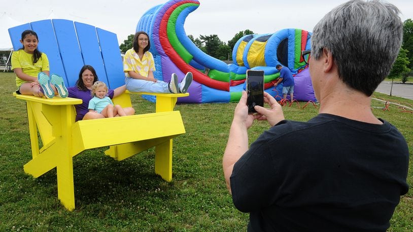 Cathy Ramirez, right, takes a photo Friday June 10, 2022 of, from left, Cecilia Ramirez, 9, Beth Conner, Charlie Stammer, 3, and Katie Conner, 13, at the city of West Carrollton's Sandmazing event located at 1 South Elm Street. MARSHALL GORBY\STAFF