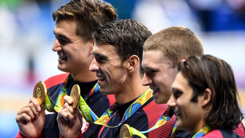 RIO DE JANERIO, BRAZIL - AUGUST 13: Michael Phelps (2nd L) of the USA poses with his team-mates as his team won gold medal after the Men's 4 x 100m Medley Relay swimming Final of the Rio 2016 Olympic Games at the Olympic Aquatics Stadium in Rio de Janeiro, Brazil on on August 13, 2016. (Photo by Salih Zeki Fazlioglu/Anadolu Agency/Getty Images)