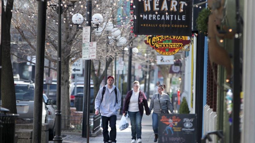 Shoppers stroll through the Dayton’s Oregon District Monday. It’s been six months since a gunman killed nine people there in a mass shooting. LISA POWELL / STAFF