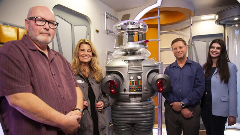 MeTV's "Collector's Call" will share the "Lost in Space" collection of New Carlisle resident Tom Pfrogner on Sunday 
L to R: Expert Doug Hines, host Lisa Whelchel, collector Tom Pfrogner and his daughter Tracie Pfrogner. - Contributed