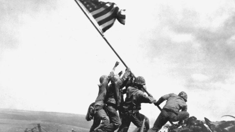 U.S. soldiers raise an American flag during the Battle of Iwo Jima, on Feb. 23, 1945.