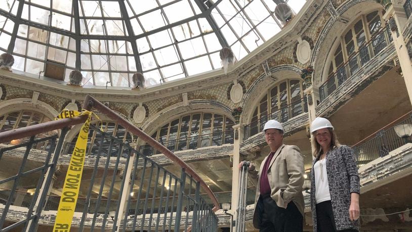 Dave Williams and Frances Mennone with Cross Street Partners visit the Dayton Arcade Thursday, after closing on $90 million to rehab the iconic complex. The arcade will reopen next year after closing in 1991. CORNELIUS FROLIK / STAFF
