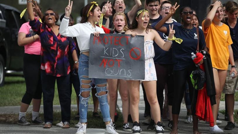 Hundreds of West Boca High School students arrive at Marjory Stoneman Douglas High School Tuesday, Feb. 20, 2018, after they walked there in honor of the 17 students and teachers who were killed in last week’s shooting massacre in Parkland, Florida.