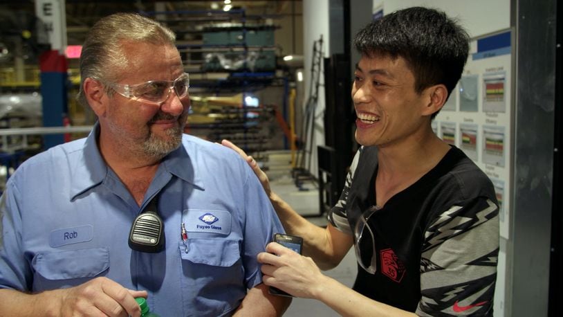 Rob Haerr and Wong He working together at the Fuyao Glass America plant in Moraine, in a photo from the film “American Factory.” CONTRIBUTED