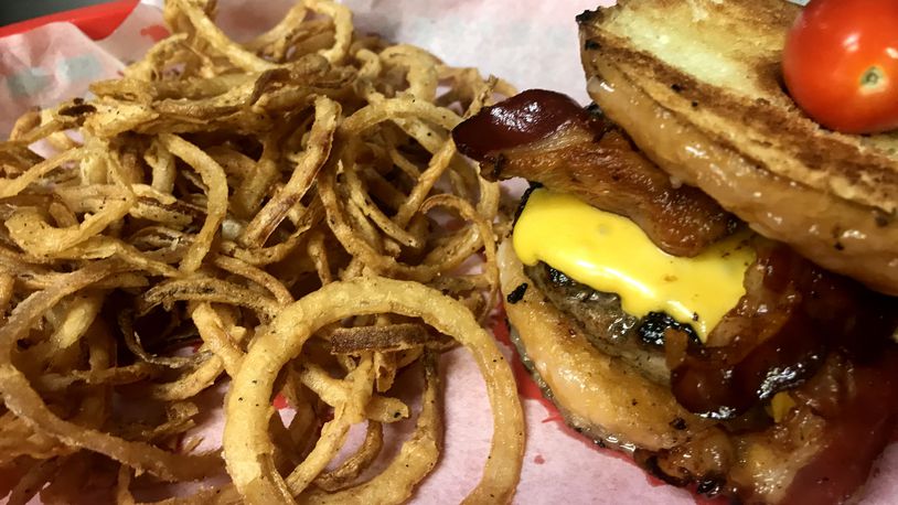 Buckin's Donkey's  Porky The Pig Doughnut Burger. Here is is served with house made onion rings.