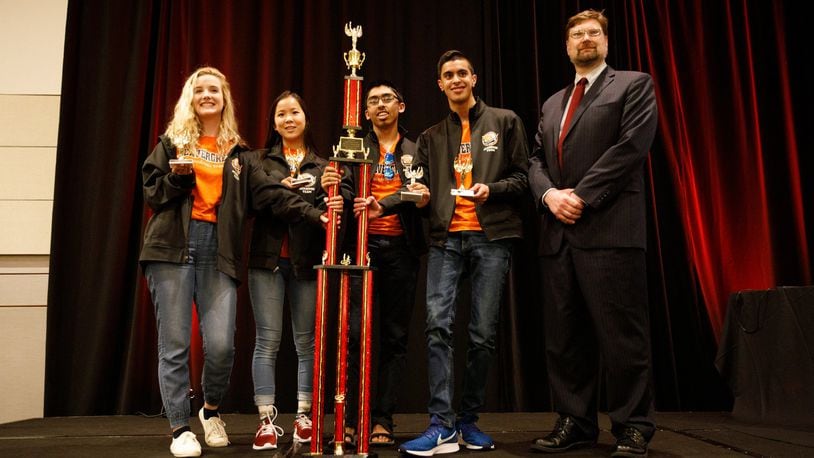 Members of the Beavercreek Quiz Bowl Team hold the trophy after winning the national championship. CONTRIBUTED