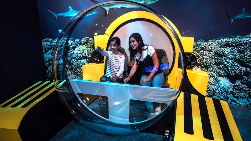 A partial replica of a Triton submersible provides a great photo opportunity for "Unseen Oceans" visitors who have cameras at the ready.  Â©AMNH/D. Finnin