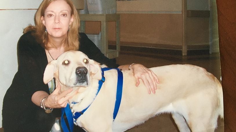 Linda Healy with her yellow Labrador Candy while doing rounds at a local nursing facility in 2007. Candy passed away shortly after her husband Chuck died in late 2014.