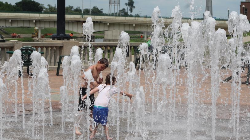 Kids play in RiverScape's interactive fountain on a recent weekday. CORNELIUS FROLIK / STAFF