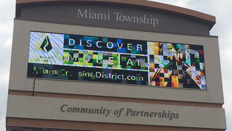 A digital billboard at the Dayton Mall is one of several ways the Miami Crossing District in the area around the mall is being promoted. NICK BLIZZARD/STAFF