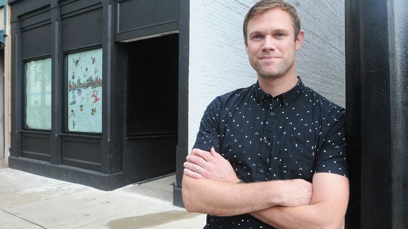 Adam Remillard stands in front of this new storefront in Miamisburg for Monocle Comics & Coffee. This is the building’s first storefront tenant in 25 years. MARSHALL GORBY\STAFF
