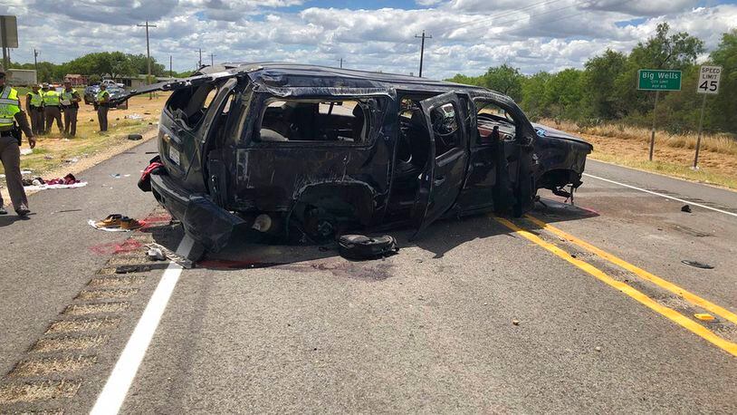 In this image tweeted by David Caltabiano of KABB/WOAI, a heavily damaged SUV is seen on Texas Highway 85 in Big Wells, Texas, after crashing while carrying more than a dozen people fleeing from Border Patrol agents, Sunday, June 17, 2018. (David Caltabiano/KABB/WOAI via AP)