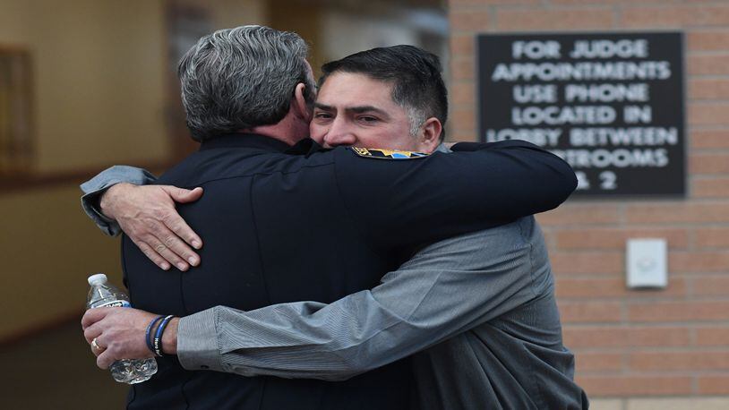 Douglas County Sheriff Tony Spurlock hugs John Castillo, father of Kendrick Castillo, who was killed in a shooting at STEM School in Highlands Ranch, at Douglas County District Court on Feb. 7, 2020, in Castle Rock, Colorado. Defendant Alec McKinney, whose birth name is Maya, was in Douglas County District Court for arraignment.