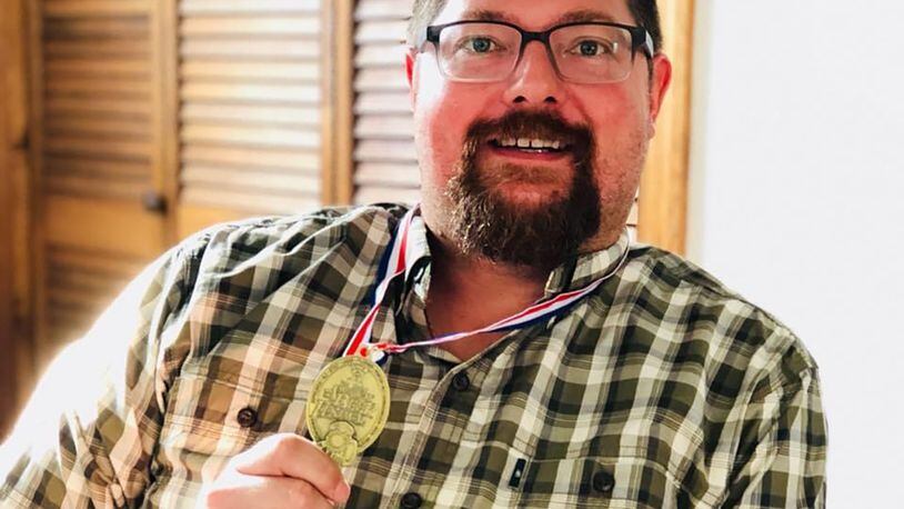 Del Hall, known as "Ohio's Beer Guy," is consuming nothing but beer and water during Lent this year as a fundraiser. He is shown with his gold medal for Barleywine from the Great American Beer Festival. CONTRIBUTED