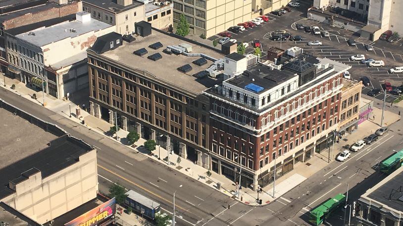 An aerial view of the corner of East Third and Jefferson streets. The 124 E. Third St. building (the tan structure) will welcome new tenants next year, the Greater Dayton Area Hospital Association and Ascend Innovations. CORNELIUS FROLIK / STAFF