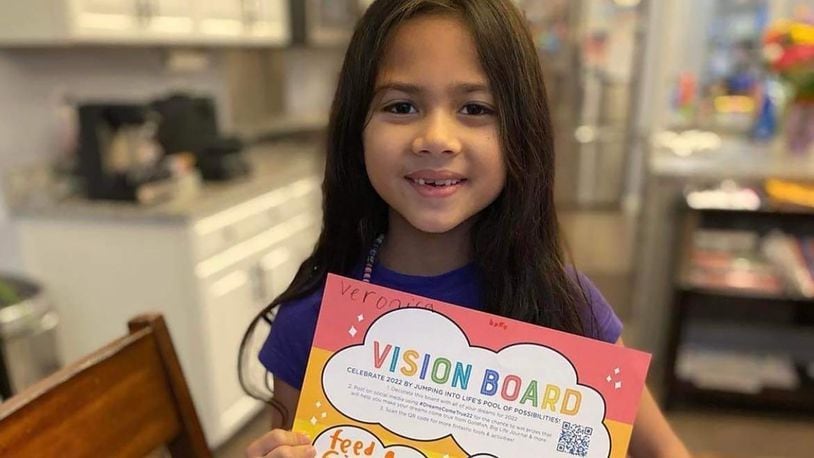 Veronica Dehner shows off her vision board, which earned her a prize of $2022 in a national contest, sponsored by Goldfish Swim School to help make her "dreams come true."