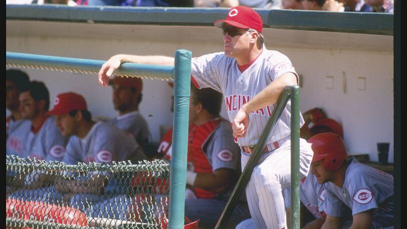 Former Reds manager Ray Knight, seen here looking on from the dugout in Wrigley Field during a 1996 game against the Cubs, was playing third base for the Reds in 1981 when a fan nearly fell over a railing in old Riverfront Stadium. He said, "I remember it clearly  . . . I saw him hanging up there, but I never knew how he actually grabbed the dang rail, the way it’s built.”