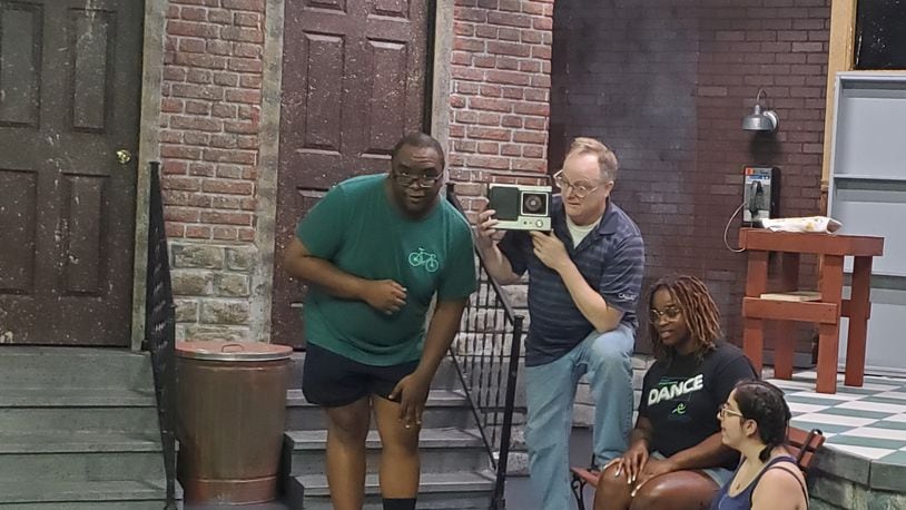 Mushnik (John Dorney) and the Urchins (Cedric Reeder-McClure, Alicia Lacey and Shana Fishbein) listen in on Seymour's radio interview about the rising popularity of Audrey II. CONTRIBUTED